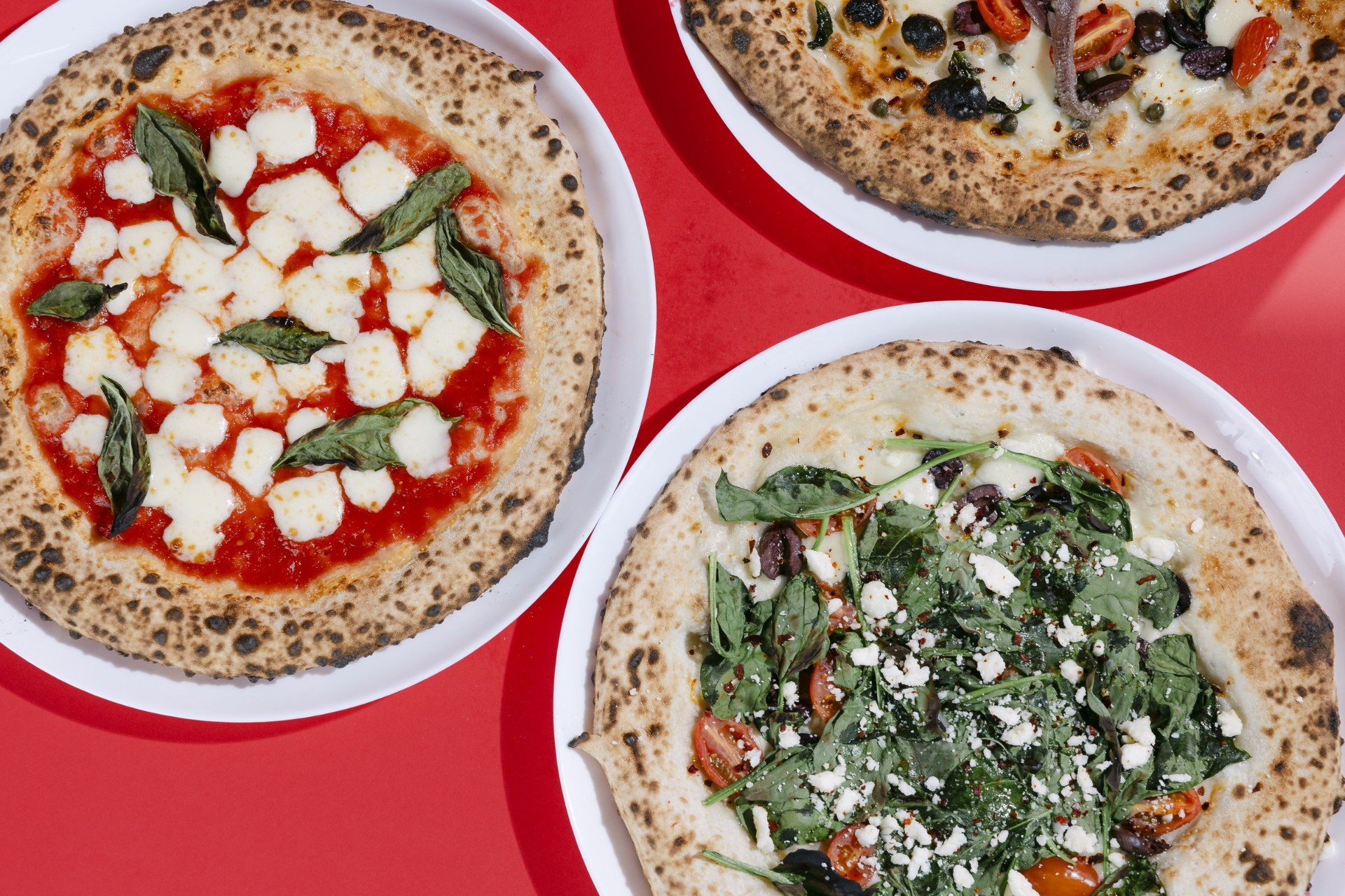 Luna Pizza Cafe — three Neapolitan pizzas on red